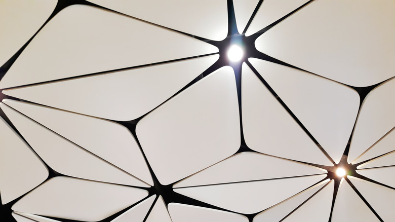 Acoustic ceiling panels with lights in geometric design