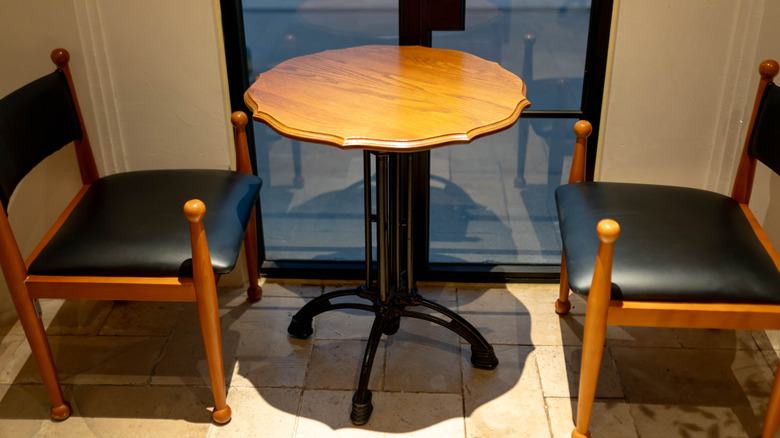 An antique table with two chairs