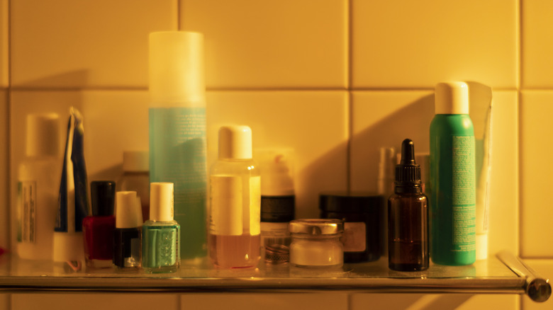 A bathroom shelf is lined with toiletries