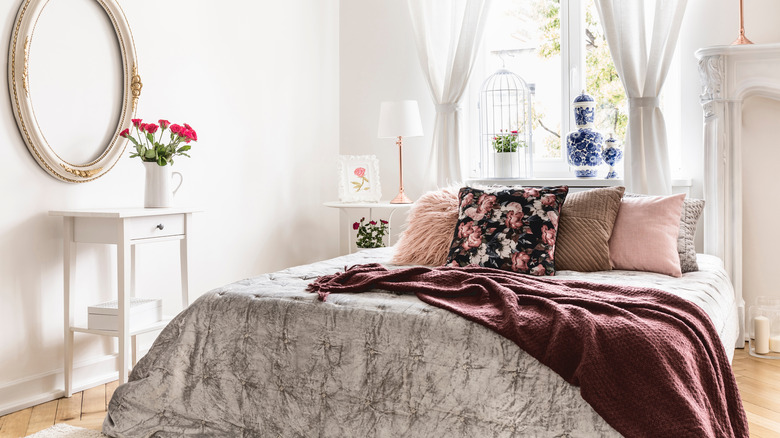 pink and floral pillow on bed