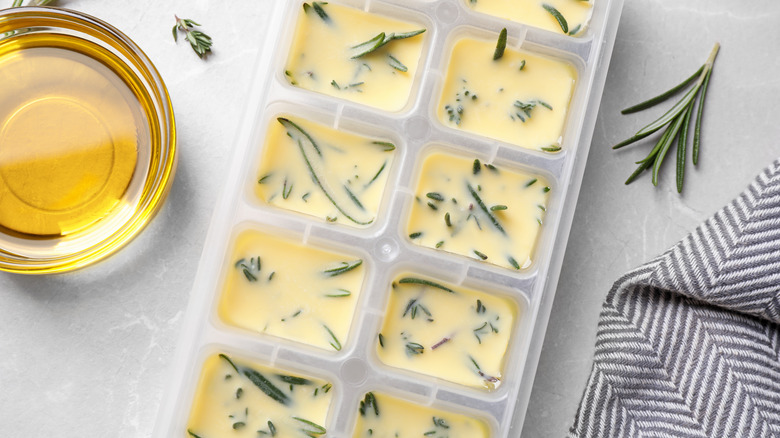 Ice tray containing frozen herbs