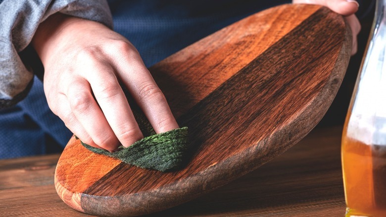 hand oiling wood cutting board