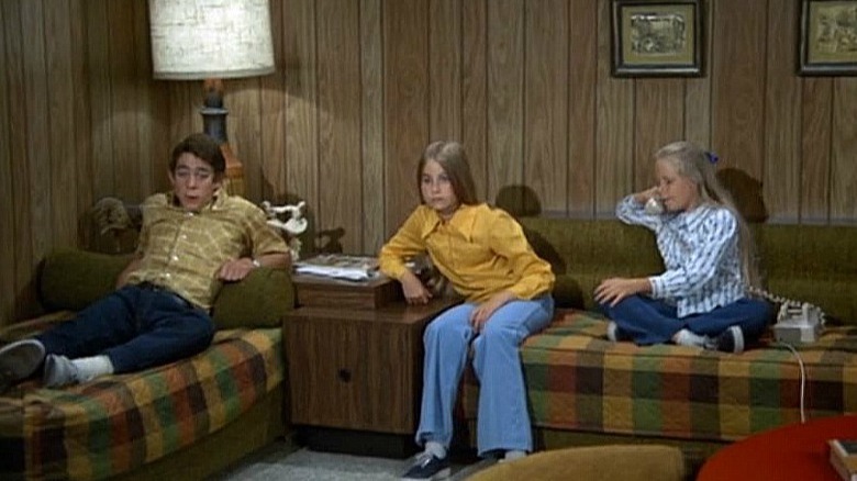 three children on sofas in living room