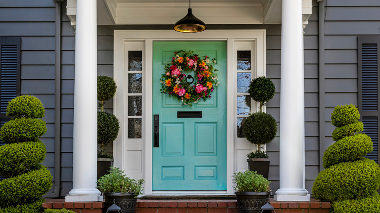 green front door with wreath