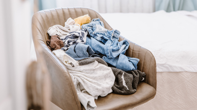 cluttered chair with clothes