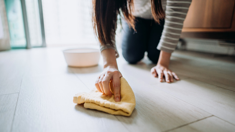 Woman hand polishing floor