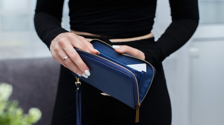 Woman holding an empty wallet