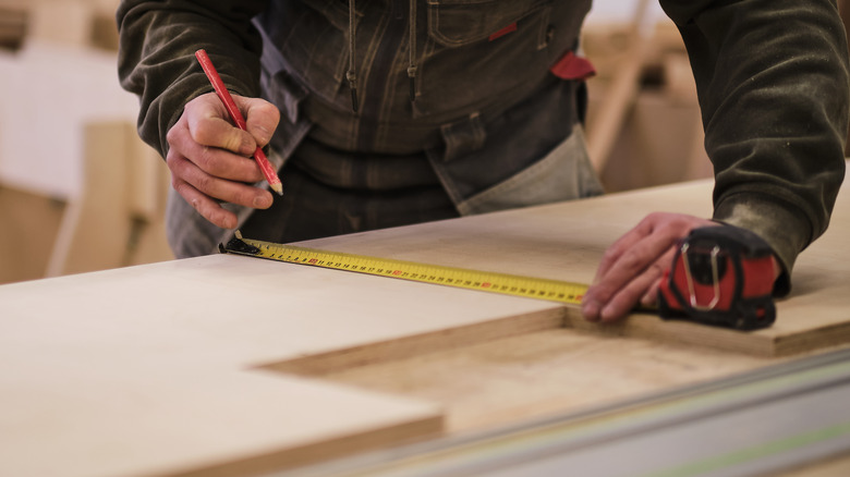 Measuring and cutting wood planks