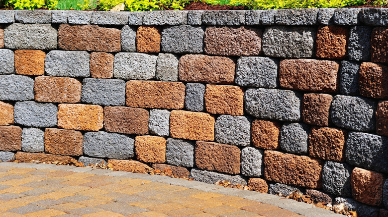 A retaining wall made with multi-colored pavers