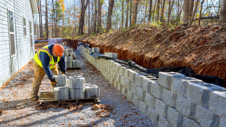 A contractor installing a retaining wall