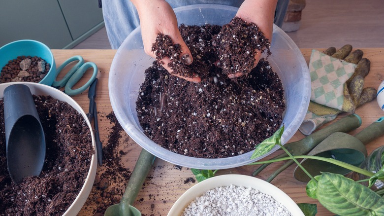 person mixing their own soil