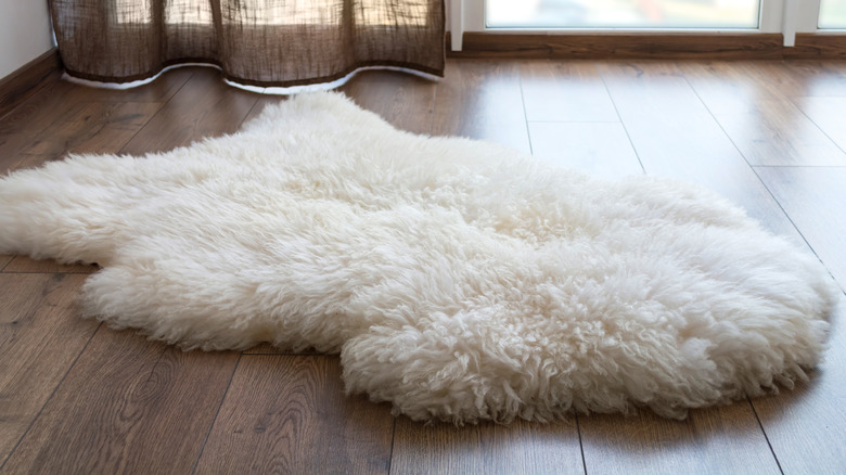 white sheepskin rug on floor