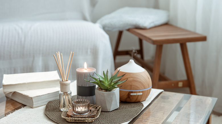 diffuser and candles on table