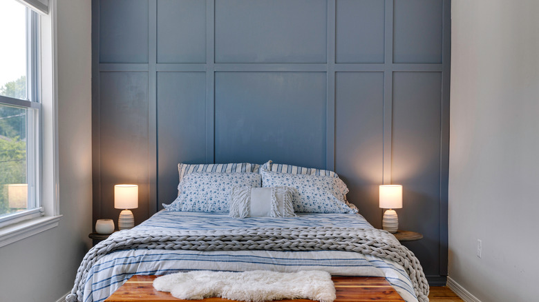 This bedroom has a blue accent wall.