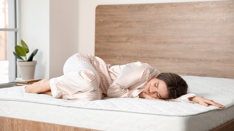 Woman sleeping on mattress