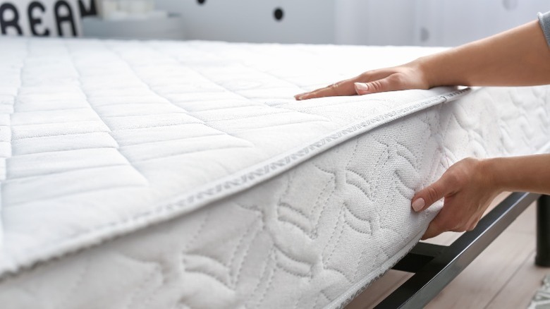 Person feeling mattress fabric 