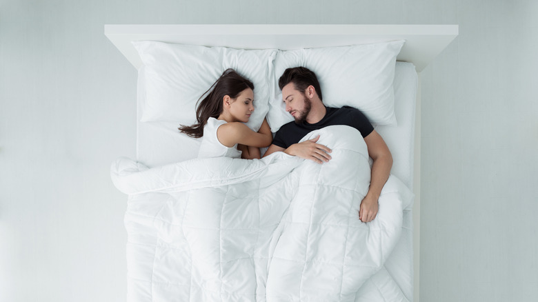 couple sleeping on mattress