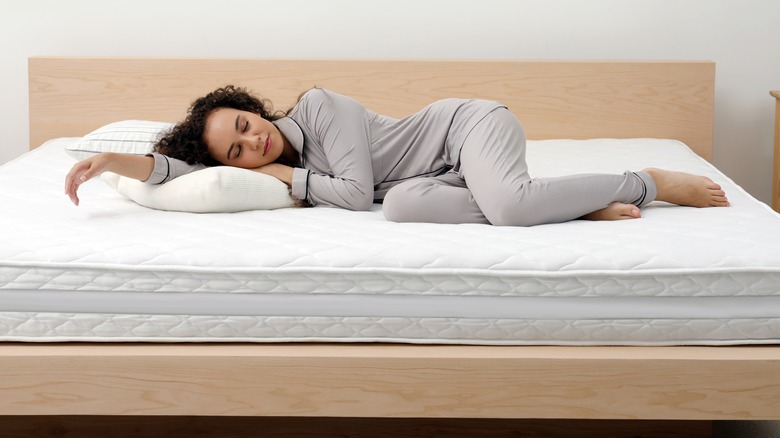Person sleeping on new mattress