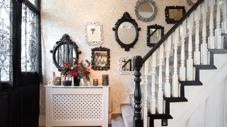 Decorative mirrors running up staircase wall in traditional home