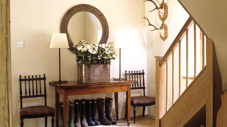 Mirror over console table and side chairs in entryway