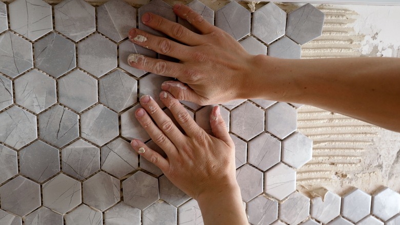 Person placing mosaic tile