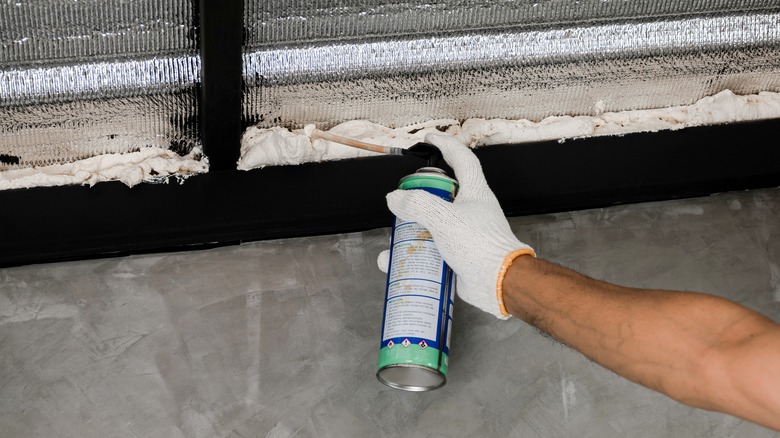 Person applying foaming caulk