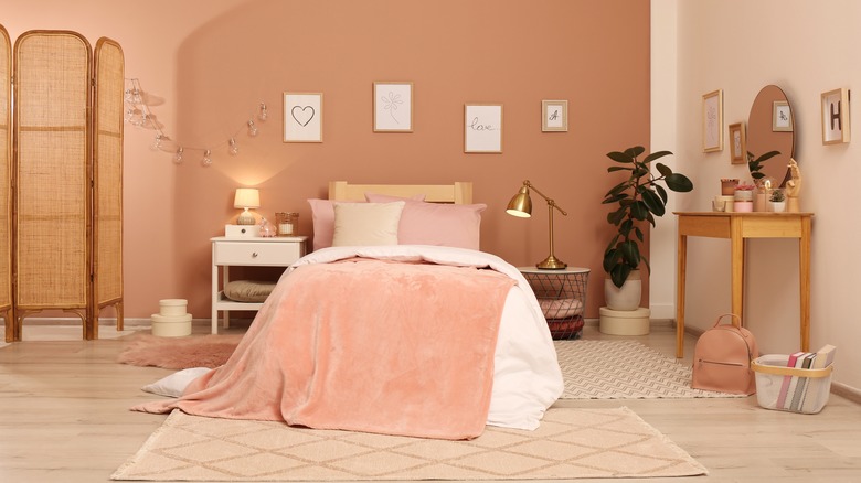 orange-pink wall in bedroom
