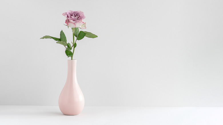 Pink bud vase with rose