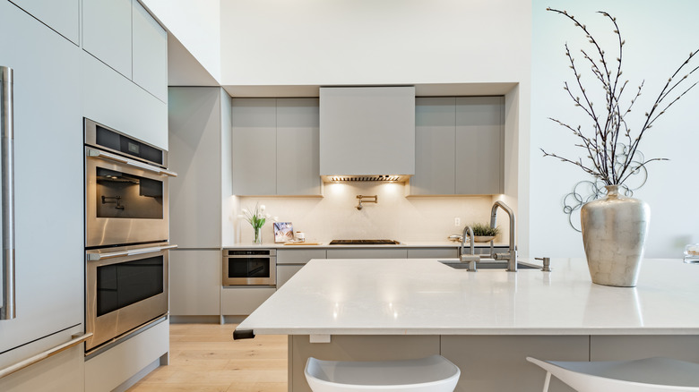 Modern kitchen with neutral white lights above the stove