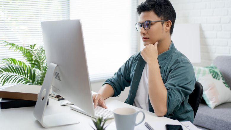 man researching on computer