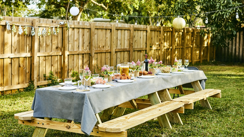 backyard with wooden fence and picnic table