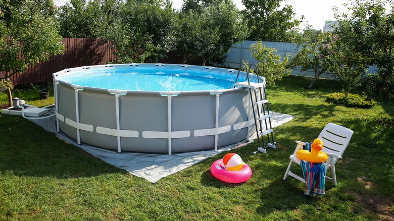 Above-ground pool with chair next to it