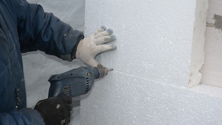 Person installing rigid foam 