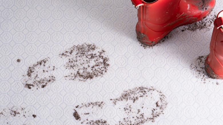 Rain boots and muddy carpet