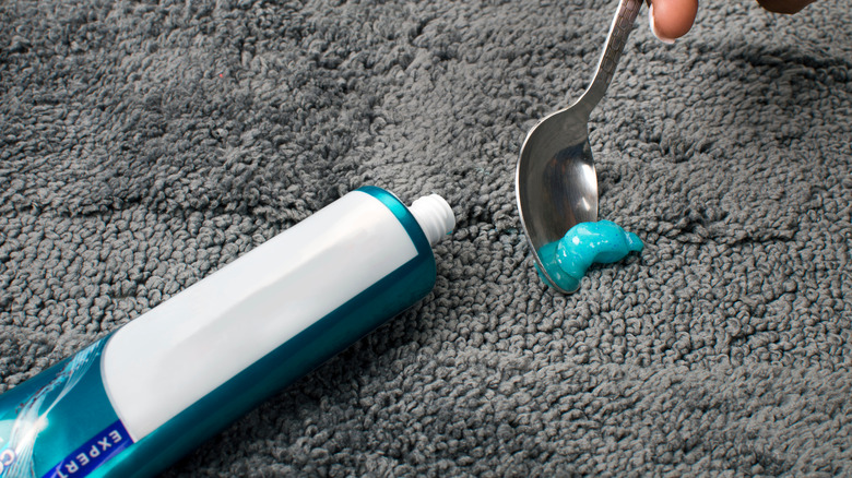 Toothpaste removed by spoon from carpet