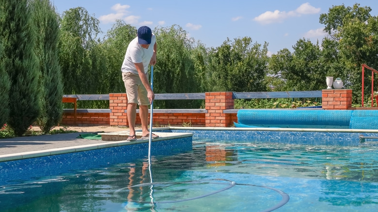 A man cleaning his pool 