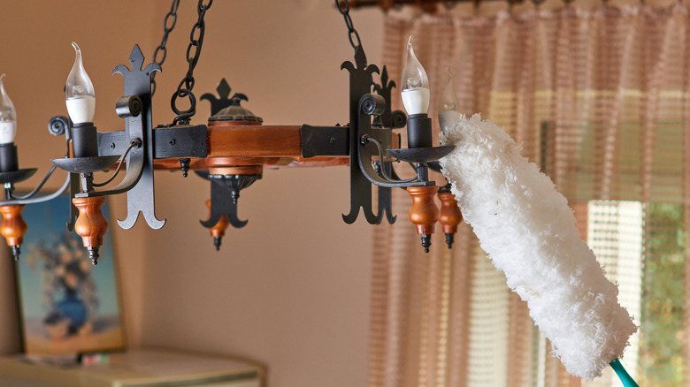 Cleaning chandelier with pole