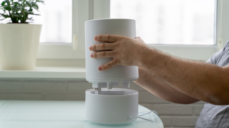 man taking a humidifier apart