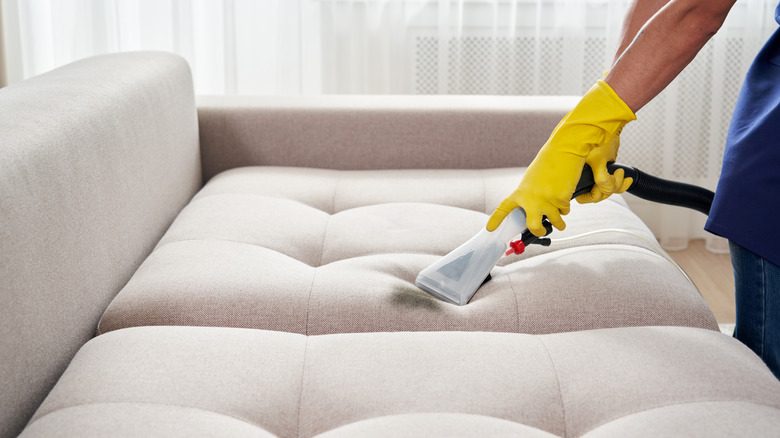 Vacuuming couch with brush attachment 