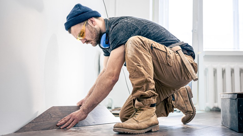 Man installing flooring in apartment