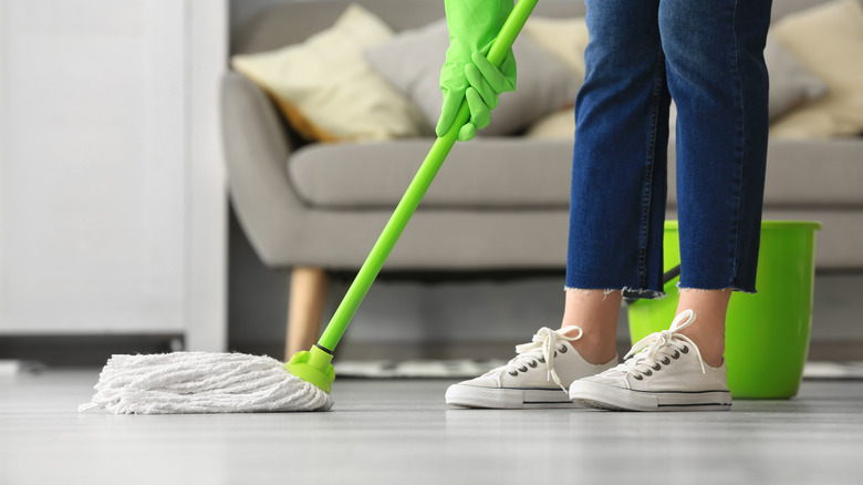 Mopping floors in living room