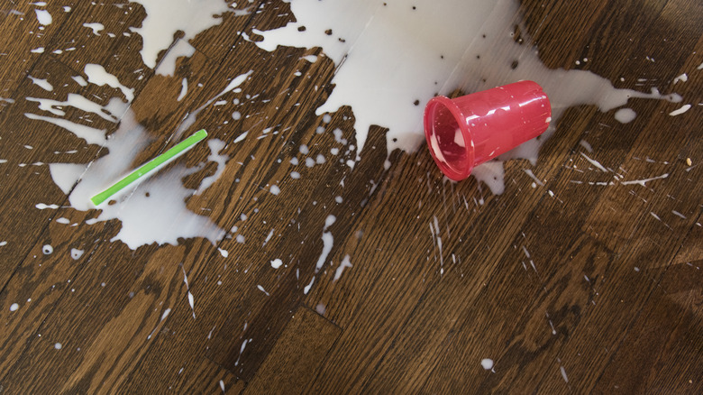 Milk spilled on hardwood floors.