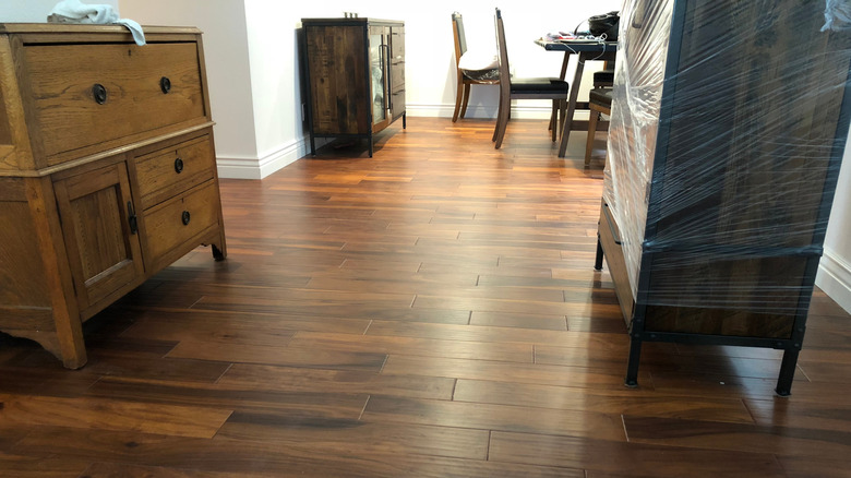 A room with dark brown engineered hardwood floors