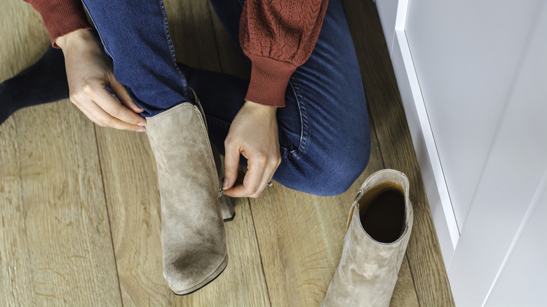 Putting suede boots on