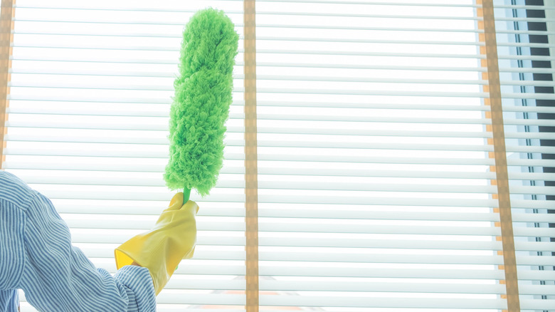 dusting blinds with a duster