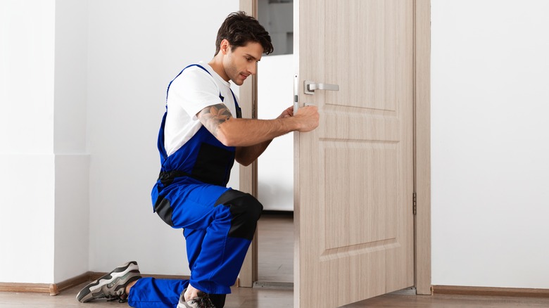 man checking door lock