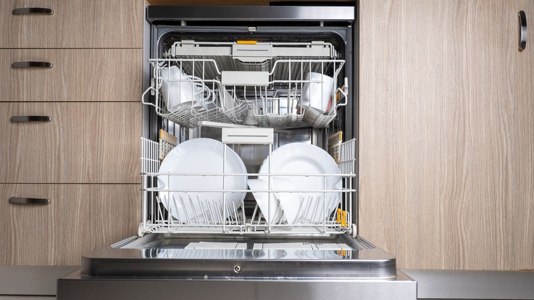 Open dishwasher with clean dishes inside