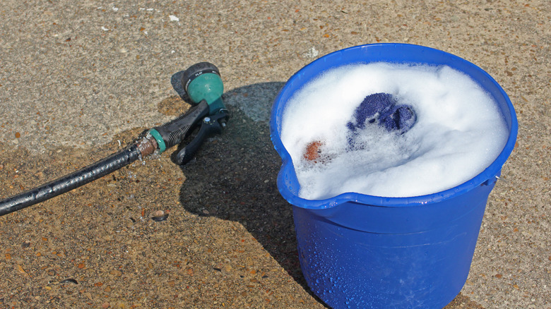 Bucket of soapy water and garden hose