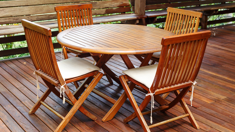 Teak wood table and chairs on a terrace