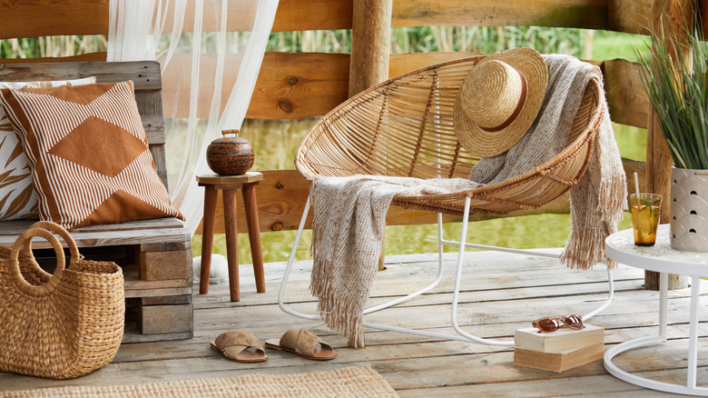 A rattan chair in a wooden gazebo